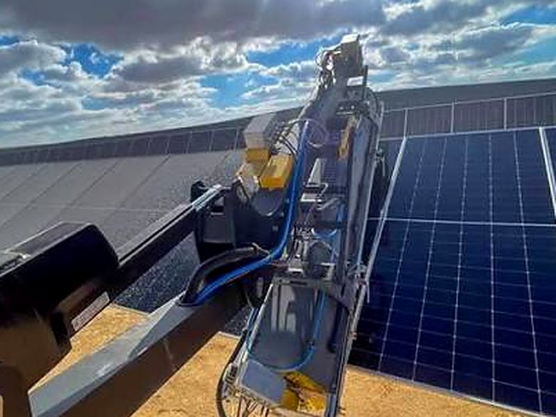 Solar panel cleaning crew washing a dusty solar array